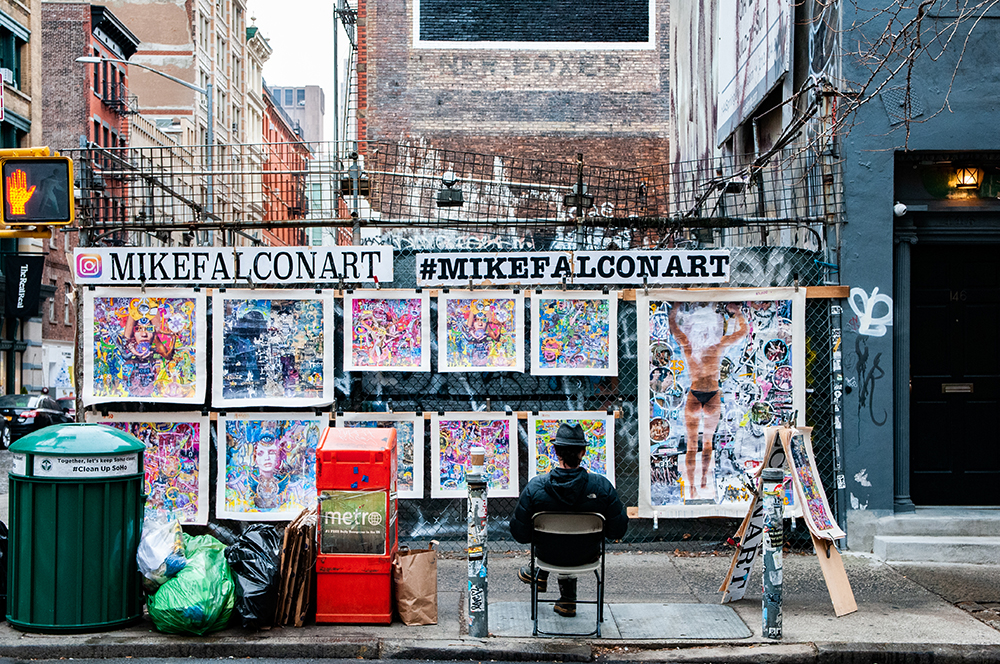 Artist selling is art in a street of New York. 2018