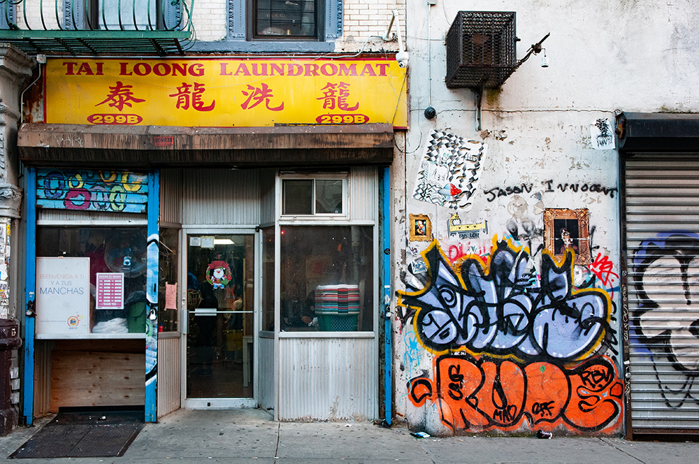Old dirty Laundromat close to Chinatown. New York 2018