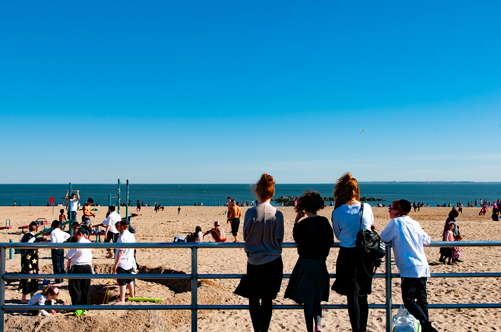 Teenagers watching people. Coney Island, Brooklyn. New York 2019.